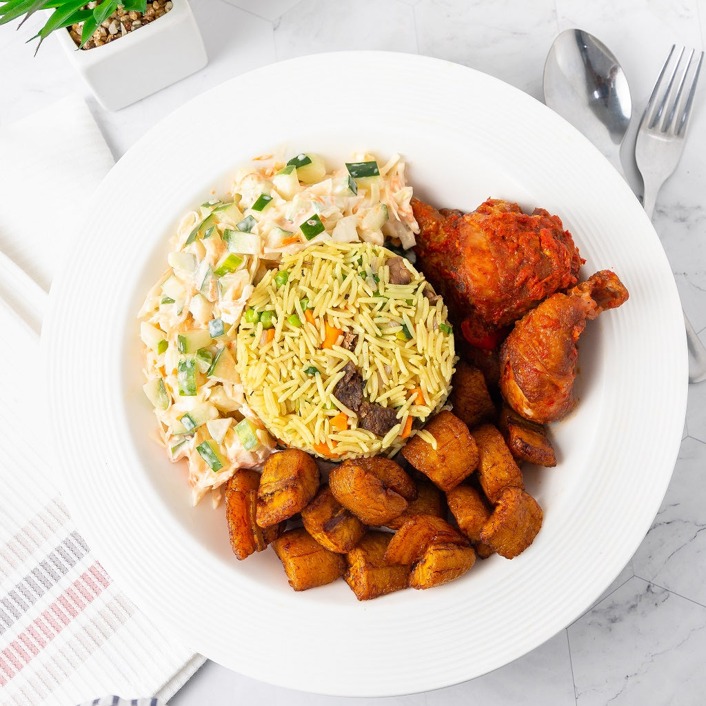 48oz bowl of Ghana Fried Rice, chicken, fried sweet plantain, and Salad