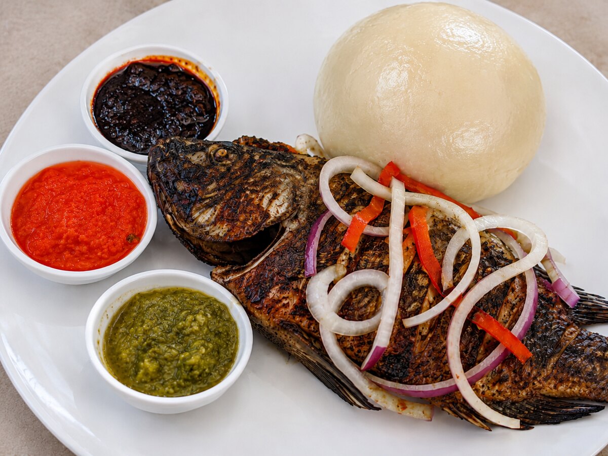 Whole Grilled Tilapia, served with original Ghana banku, red pepper sauce, The Doctor's Menu Chilli Sauce(shi-tor) and vegetables